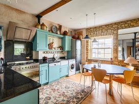 A kitchen with a table and chairs at Beautiful Pad Near World Heritage Jurassic Coast in Pymore near Bridport