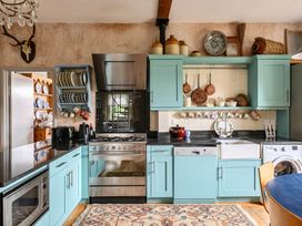 A kitchen with cabinets, stove, sink and refrigerator at Beautiful Pad Near World Heritage Jurassic Coast in Pymore near Bridport