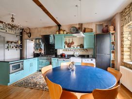 A kitchen with a blue table and orange chairs at Beautiful Pad Near World Heritage Jurassic Coast, Pymore near Bridport