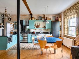 A kitchen with dining area and appliances at Beautiful Pad Near World Heritage Jurassic Coast Pymore near Bridport