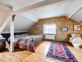 A bedroom with a bed and decorative rug at Beautiful Pad Near World Heritage Jurassic Coast in Pymore near Bridport