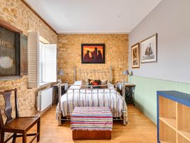 A bedroom with a bed and chair at Beautiful Pad Near World Heritage Jurassic Coast in Pymore near Bridport