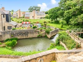 A view of houses and water with a bridge at Beautiful Pad Near World Heritage Jurassic Coast in Pymore near Bridport