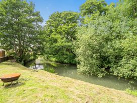 A garden with trees and a stream at Beautiful Pad Near World Heritage Jurassic Coast Pymore near Bridport