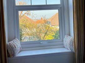 A window with cushions on the sill at The Old Barn in Llandudno