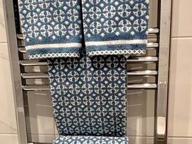 Towels hanging on a chrome towel rack in a bathroom