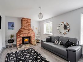 A living room with a fireplace and sofa at Detached House in Quiet Village Pets Allowed Ashbocking near Otley, Suffolk