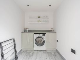 A laundry room with a washing machine and countertop at Detached House in Quiet Village Pets Allowed, Ashbocking near Otley, Suffolk