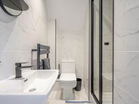 A bathroom with a sink, toilet, shower and mirror at Detached House in Quiet Village Pets Allowed Ashbocking near Otley, Suffolk