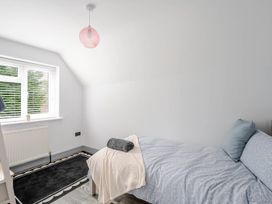 A bedroom with a bed and window at Detached House in Quiet Village Pets Allowed Ashbocking near Otley, Suffolk