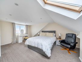 A bedroom with a bed and a desk at Cottage Sleeps 6 with Parking and Garden Bridlington