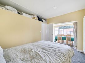 A bedroom with a bed and a doorway leading to a dining area at Cottage Sleeps 6 with Parking and Garden in Bridlington
