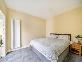 A bedroom with a bed and bedside table at Cottage Sleeps 6 with Parking and Garden in Bridlington