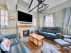 A living room with a sofa and coffee table at 4 Bed Sleeps 8 Pool Table Sea View Parking in Swanage