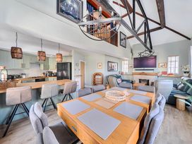 A dining area with a table and chairs at 4 Bed Sleeps 8 Pool Table Sea View Parking in Swanage