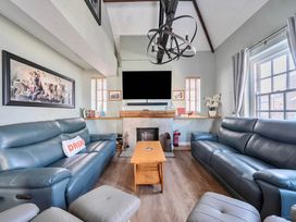 A living room with a sofa and coffee table at 4 Bed Sleeps 8 Pool Table Sea View Parking in Swanage