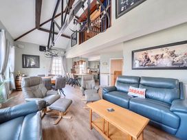 A living room with sofa and dining area at 4 Bed Sleeps 8 Pool Table Sea View Parking in Swanage