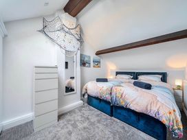 A bedroom with two beds and a chest of drawers at 4 Bed Sleeps 8 Pool Table Sea View Parking in Swanage
