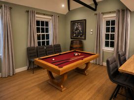 A game room with a pool table and chairs at 4 Bed Sleeps 8 Pool Table Sea View Parking in Swanage