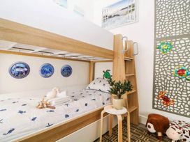 A bunk bed with nautical decor and a plant in a bedroom at The Seaside Retreat in Miami