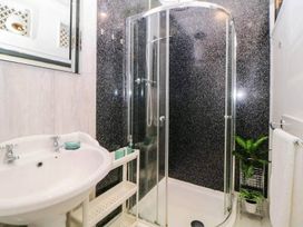 A bathroom with a shower and sink at an unspecified location