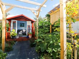 A garden with a shed and plants at The Old Barn in Manchester