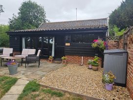 An outdoor patio area with a table and seating at Lily's Cottage Suffolk Sleeps 2 with Pets Mendlesham Green near Stowmarket