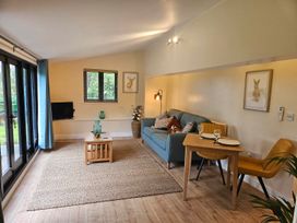 A living room with a sofa and dining table at Lily's Cottage Suffolk Sleeps 2 with Pets Mendlesham Green near Stowmarket