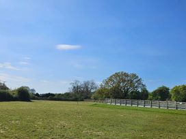 An open field with trees and a fence at Lily's Cottage Suffolk Sleeps 2 with Pets Mendlesham Green near Stowmarket