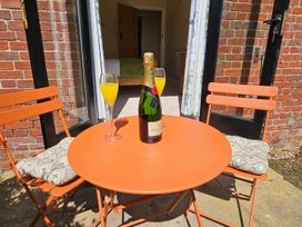 A table with a champagne bottle and drinks at Lily's Cottage Suffolk Sleeps 2 with Pets in Mendlesham Green near Stowmarket