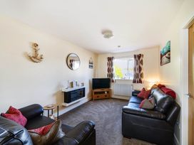 A living room with a television and sofa at Seaside Chalet Retreat in Bridlington