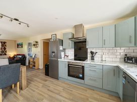 A kitchen with cabinets and appliances at Seaside Chalet Retreat in Bridlington