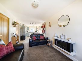 A living room with a sofa and television at Seaside Chalet Retreat in Bridlington