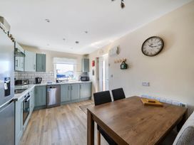 A kitchen with a table and chairs at Seaside Chalet Retreat in Bridlington