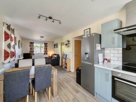 A kitchen and dining area with a dining table and chairs at Seaside Chalet Retreat in Bridlington