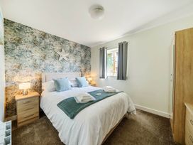 A bedroom with a bed and bedside tables at Seaside Chalet Retreat in Bridlington