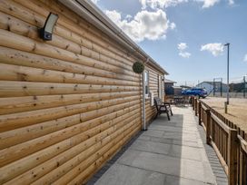 A wooden wall with a table and chairs outside Seaside Chalet Retreat in Bridlington