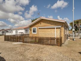 A wooden cabin with a fence at Seaside Chalet Retreat in Bridlington