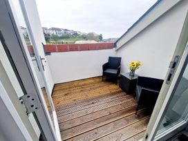 A balcony with two chairs and a table at Apartment Sleeps 4 with Balcony and Parking in Kingsbridge