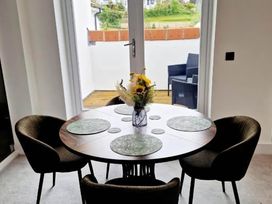 A dining room with a round table and chairs at Apartment Sleeps 4 with Balcony and Parking in Kingsbridge
