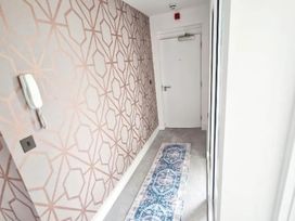 A hallway with a patterned wall and a door at Apartment Sleeps 4 with Balcony and Parking in Kingsbridge