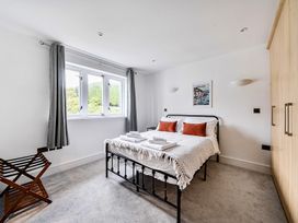 A bedroom with a bed, wardrobe, and windows at Apartment Sleeps 4 with Balcony and Parking in Kingsbridge
