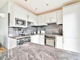 A kitchen with appliances and cabinets at Torpoint Apartment Sleeps4 Seaside Parking Downderry