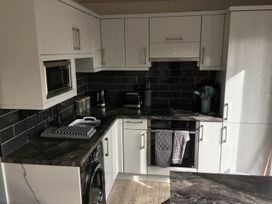 A kitchen with appliances and cabinets at Torpoint Apartment Sleeps4 Seaside Parking Downderry