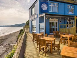 An outdoor seating area with tables and chairs at Torpoint Apartment Sleeps4 Seaside Parking in Downderry