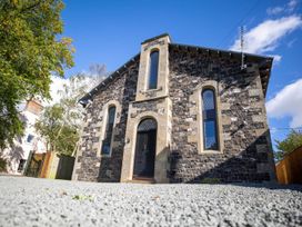 A stone building with windows and a front door at Stunning 3 Bed Converted Village Hall Near Kelso Nenthorn near Kelso