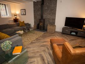 A living room with a sofa and fireplace at Stunning 3 Bed Converted Village Hall Near Kelso in Nenthorn near Kelso