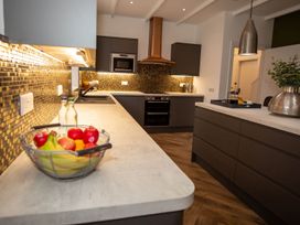 A kitchen with a counter and a bowl of fruit at Stunning 3 Bed Converted Village Hall Near Kelso