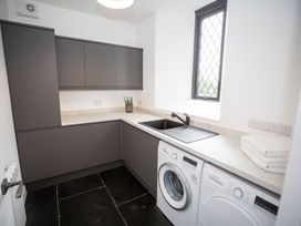 A utility room with a washing machine and sink at Stunning 3 Bed Converted Village Hall Near Kelso Nenthorn near Kelso