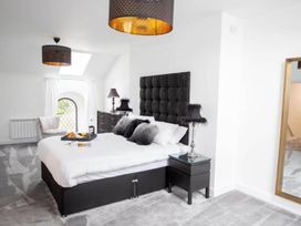 A bedroom with a bed and bedside table at Stunning 3 Bed Converted Village Hall Near Kelso Nenthorn near Kelso